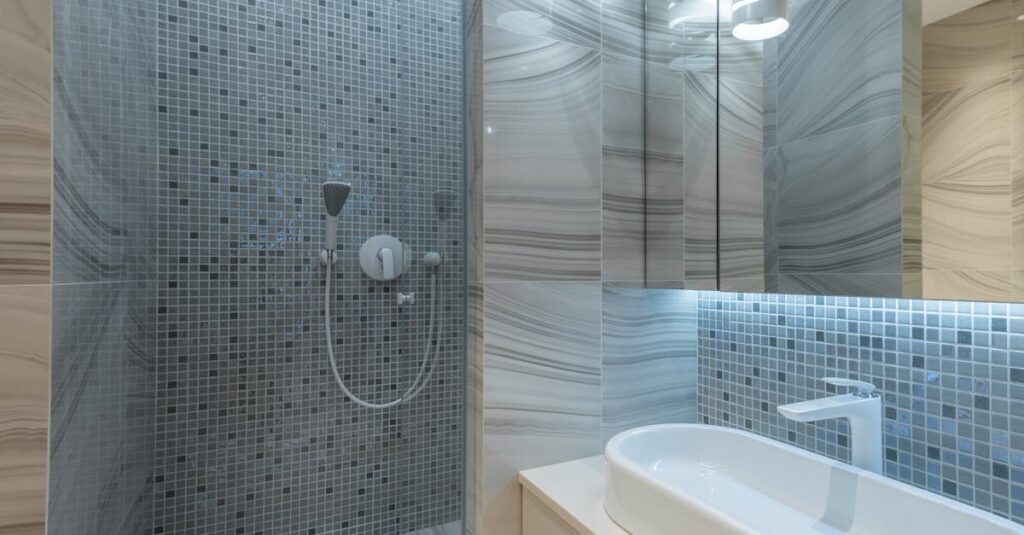 Stylish modern bathroom interior design with shower enclosure and oval sink under creative luminous lamp